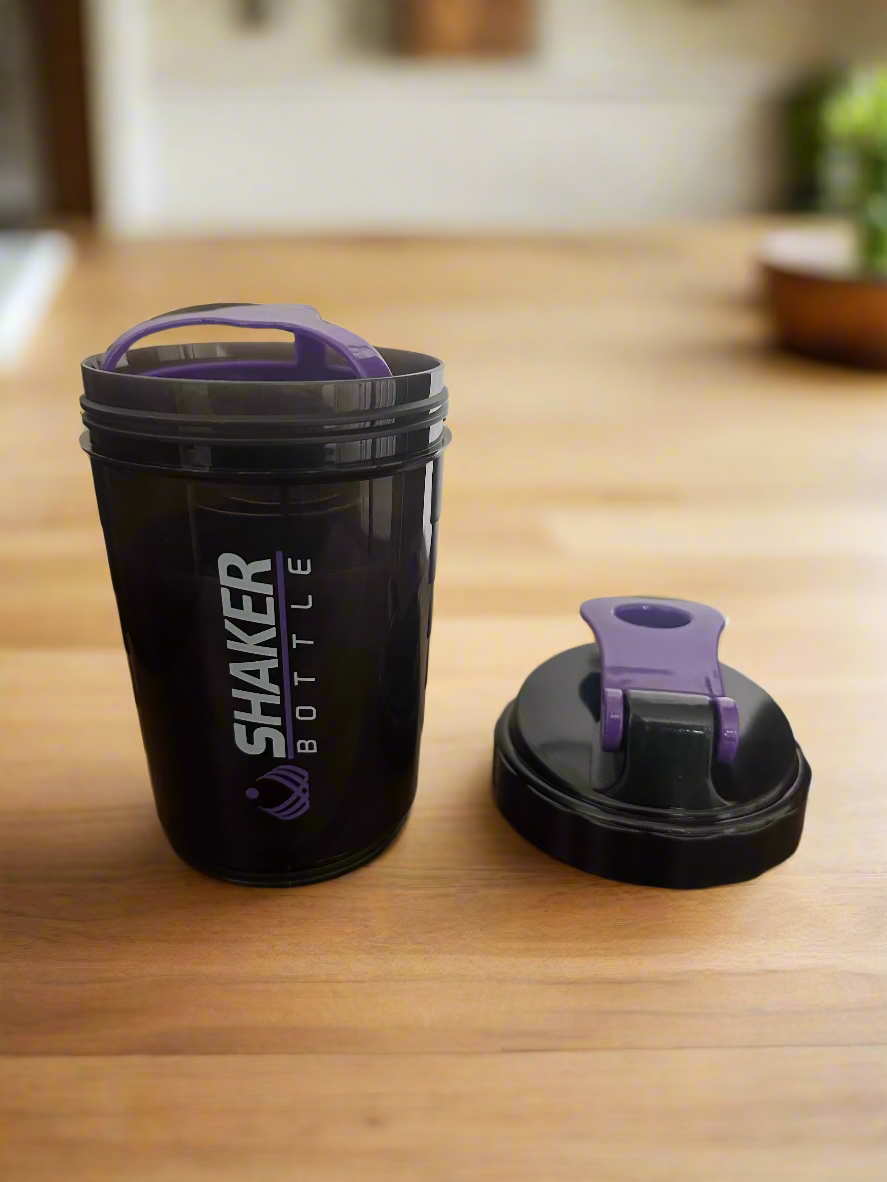 Black shaker bottle with purple lid  on for fitness