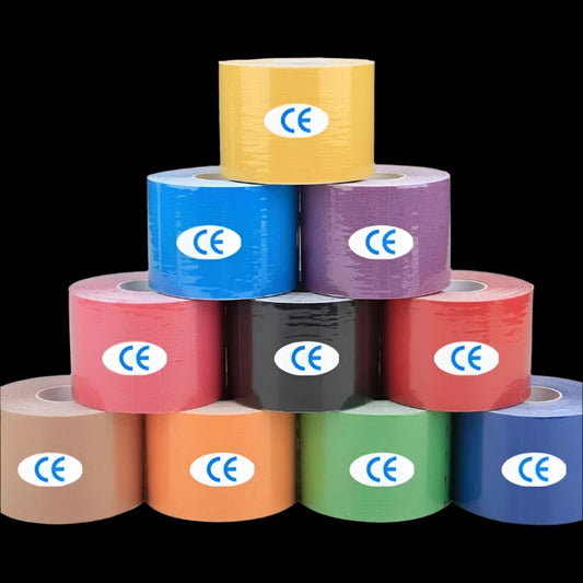 Multiple rolls of kinesiology tape in various colors displayed in a stacked arrangement, with a blurred image of a person in the background.