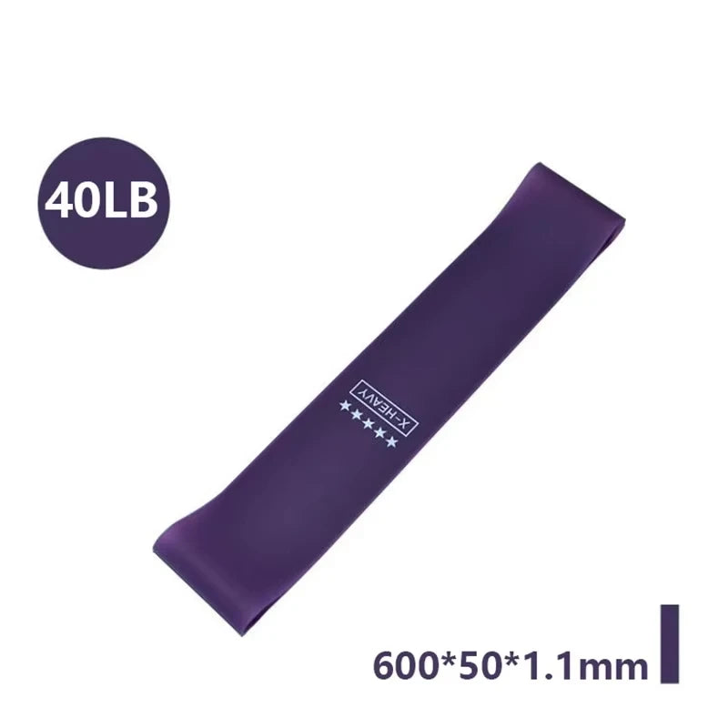 Five resistance bands in varying colors of pink, purple, and blue, labeled with resistance levels and sizes, with a carry bag.