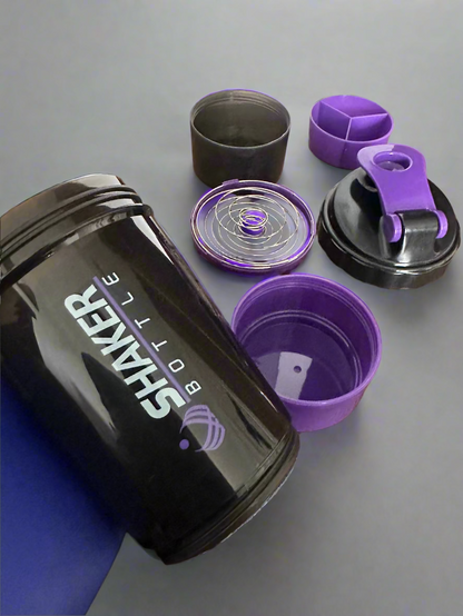 Black and purple shaker bottle with accessories on a wooden surface